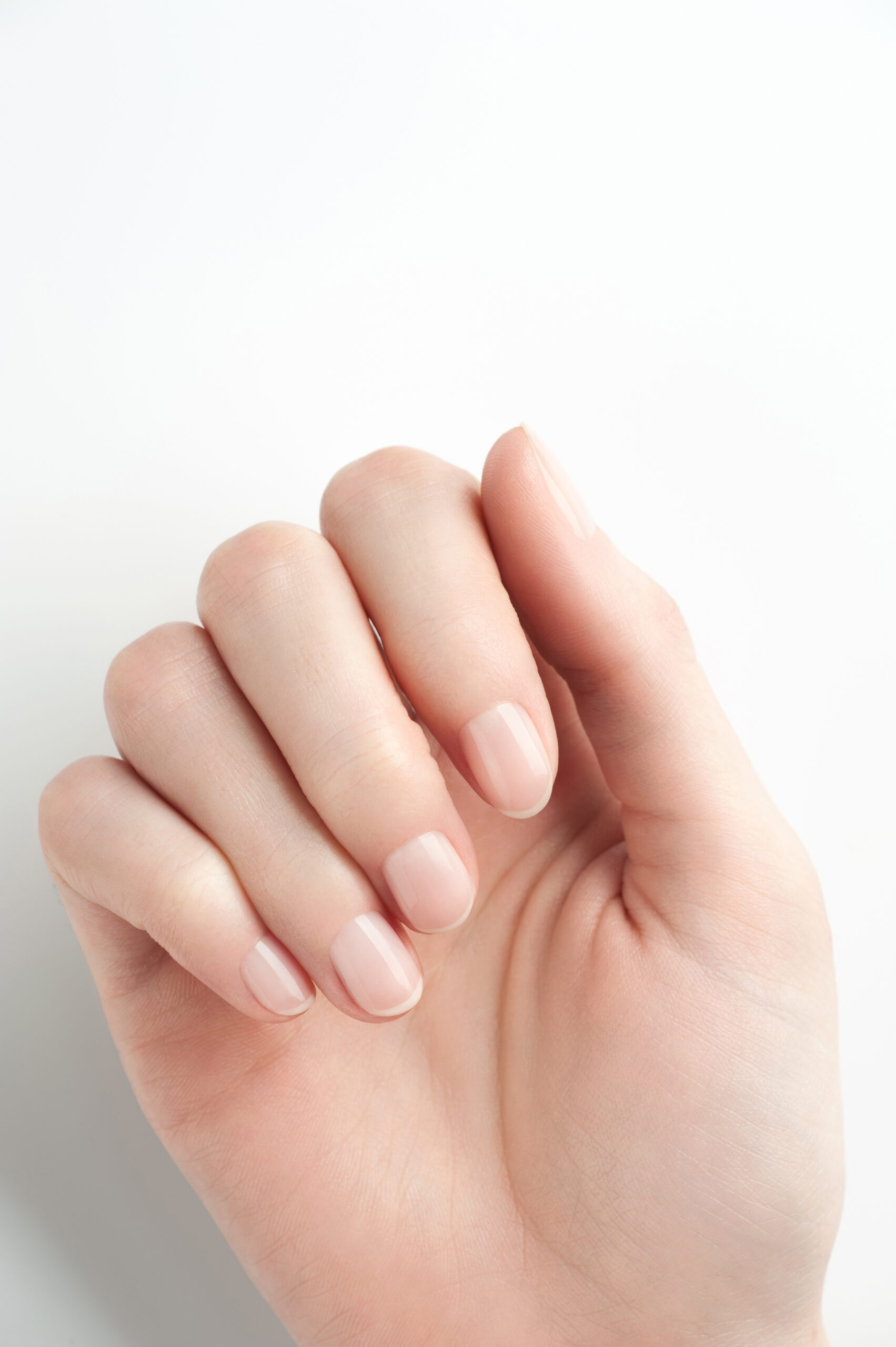 Closeup image of woman hand with beautiful nude manicure